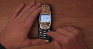 Budapest, Hungary - Circa 2022: Classic game Snake II being played on a Nokia 6310i cellphone, iconic device from the early 2000s, timelapse fast motion