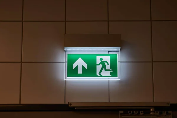 Emergency exit sign glowing in the dark