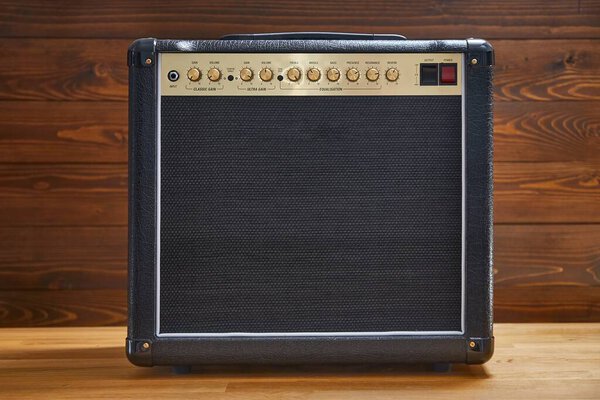 Guitar combo amplifier in front of lumber wall