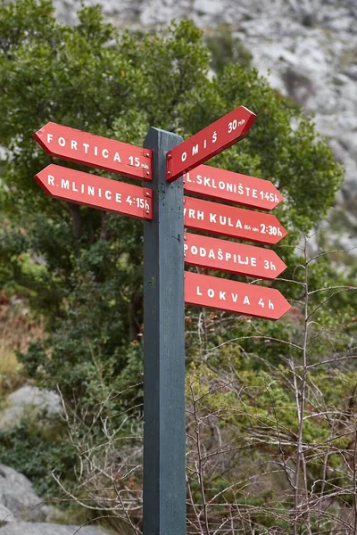 Direction signs against on a mountain hiking trail, in the croatian mountain range velebit near Omis