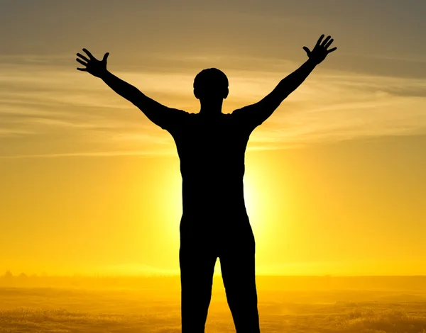 Silhouette of man on the field in the morning at sunrice — Stock Photo, Image