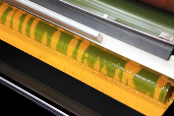 Yellow ink in a printing press — Stock Photo, Image