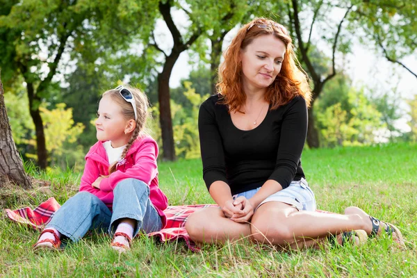 Sad mother and little daughter having a quarrel, looking in diff — Stock Photo, Image