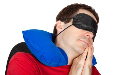 Man with travel Neck Pillow and Sleeping mask sleep in a armchai clipart
