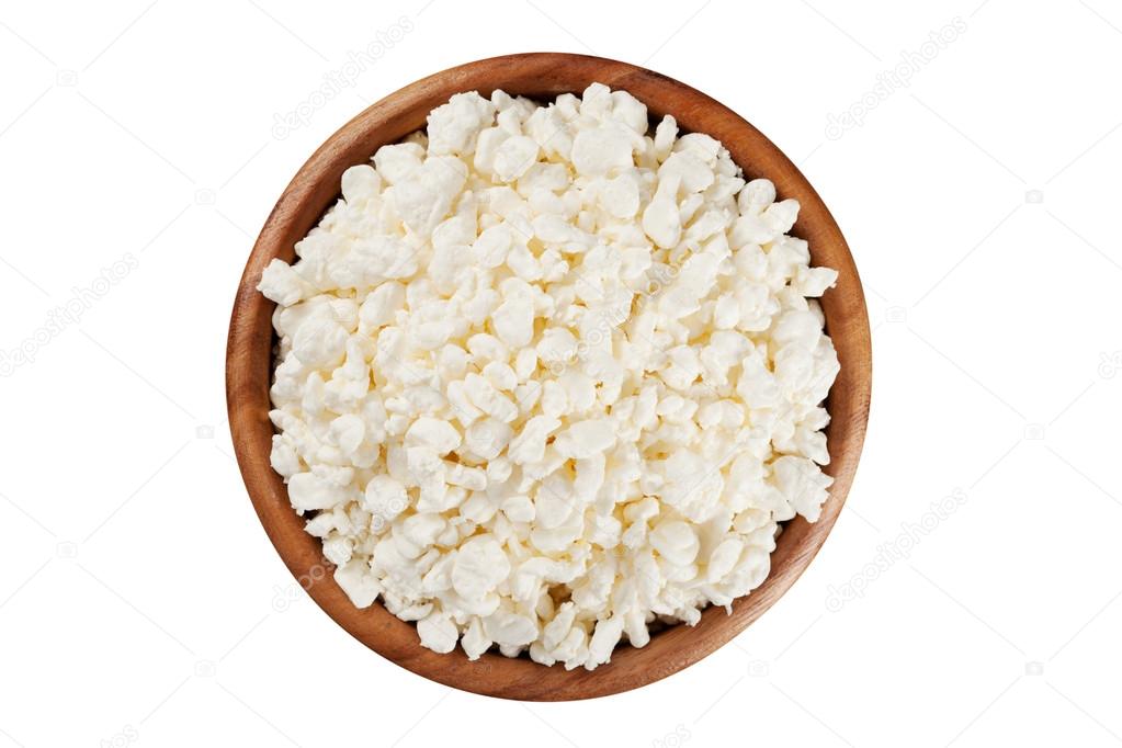 Cottage cheese in the rustic wooden plate