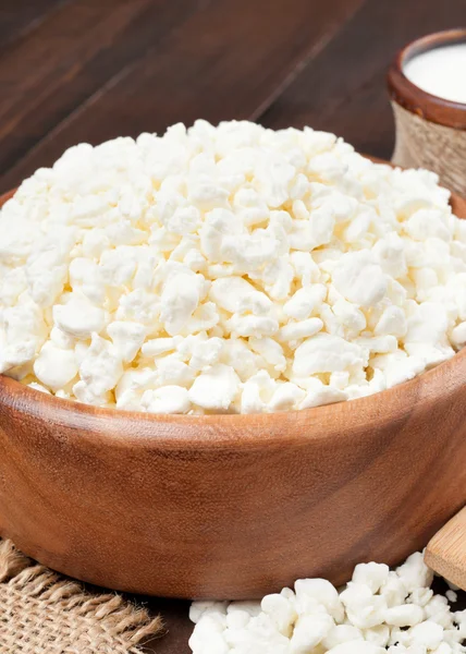 Cottage cheese in rustic wooden bowl — Stock Photo, Image