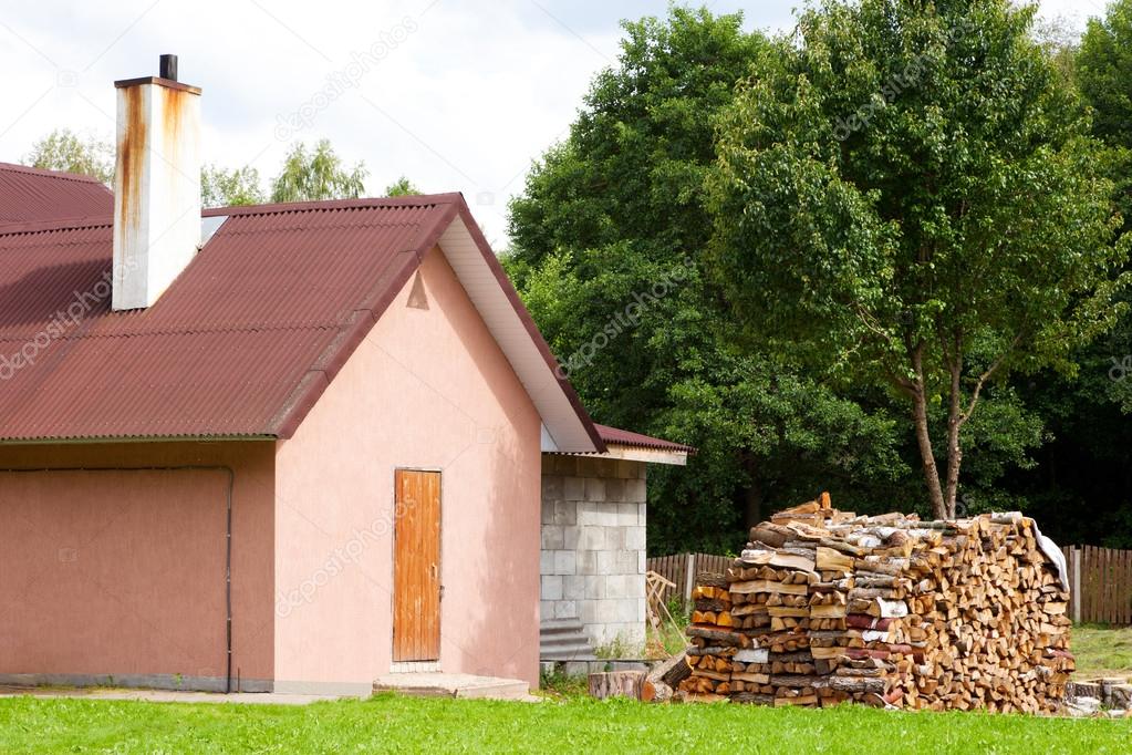small house with firewood outside