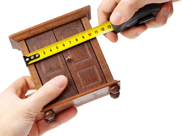 Woodworker measuring wardrobe with a tape measure, carpentry con — Stock Photo, Image