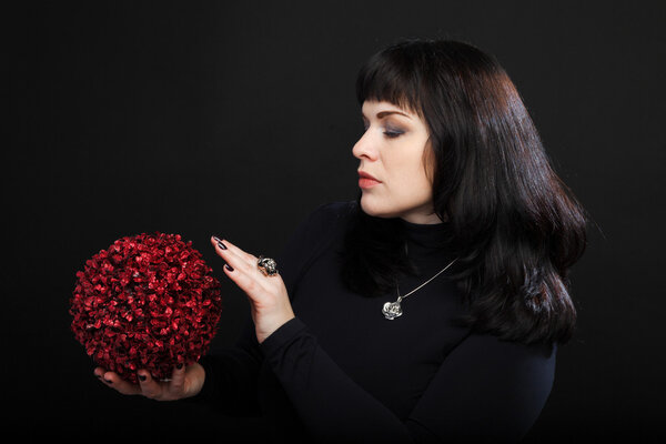 Wizard woman or fortune teller holds red magic ball