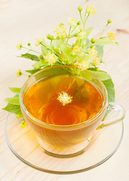 Linden flowers and cup of healthy tea, herbal medicine — Stock Photo, Image