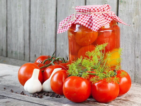 Homemade tomatoes in glass jar. Fresh and canned tomatoes on woo — Stock Image Homemade tomatoes in glass jar. Fresh and canned tomatoes on woo Stock Image
