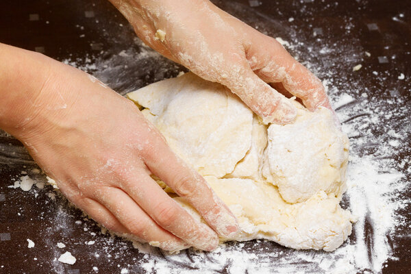 female hands kneading dough
