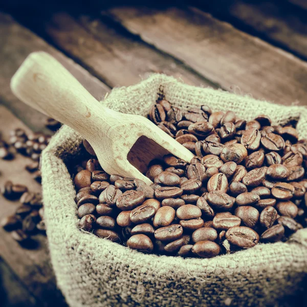 Vintage stylized photo of sack with coffee beans — Stock Photo, Image