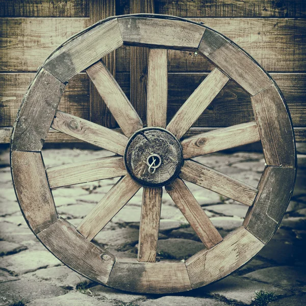 Vintage stylized photo of wooden cart wheel — Stock Photo, Image