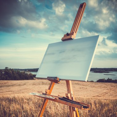 Canvas rests on a easel on lake landscape, retro stylized