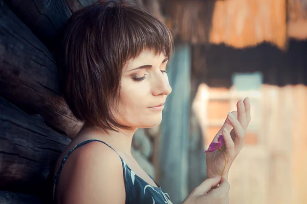 Beautiful woman with pink flower — Stock Photo, Image