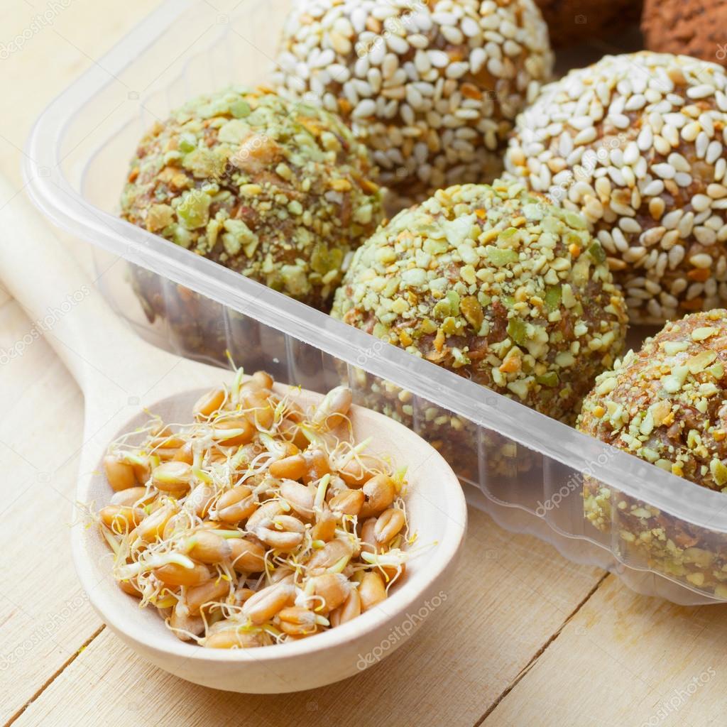 Balls from ground wheat sprouts with sesame and seeds
