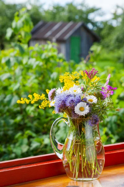 Bouquet of summer flowers and healing herbs in jug — Stock Photo, Image