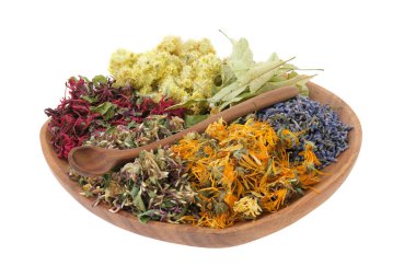 Wooden plate of medicinal herbs, isolated on white. Healing plants, ingredients for making of herbal medicine drugs, tea or infusion. Alternative and herbal medicine concept.