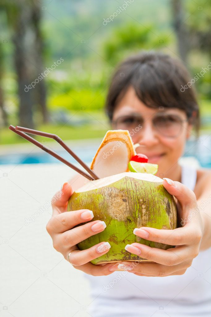 Close-up portrait young pretty woman drinking coconut cocktail 