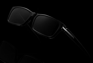Black sunglasses isolated on black background