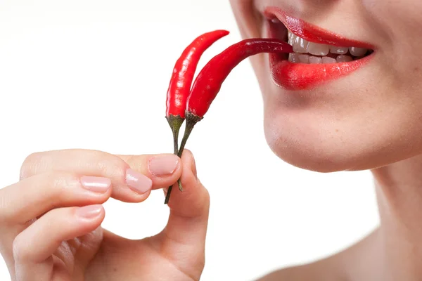 Young woman with chili pepper isolated on white — Stock Photo, Image