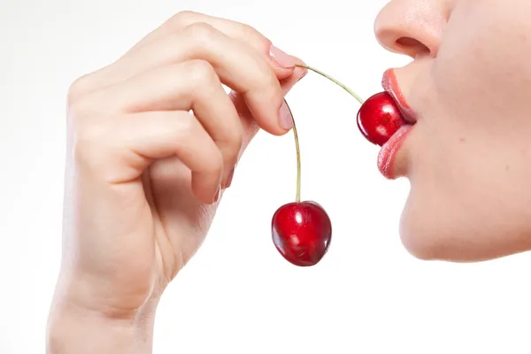 Young woman with cherry isolated on white Stock Photo