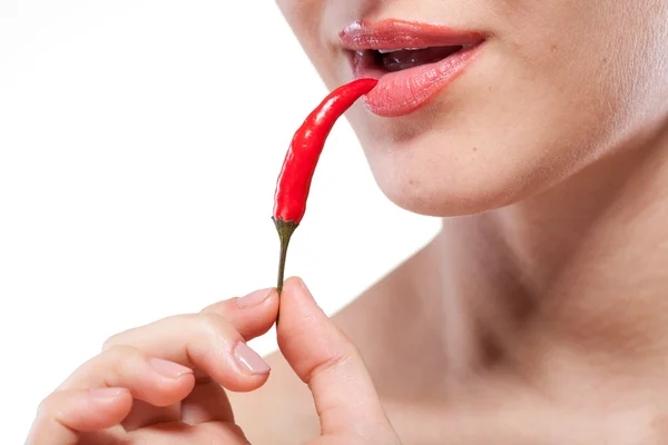 Young woman with chili pepper isolated on white — Stock Photo, Image