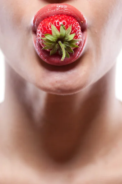 Young woman biting strawberry isolated on white Stock Photo