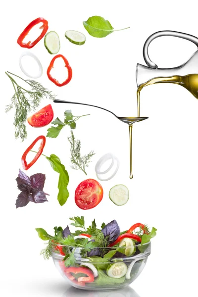 Falling vegetables for salad and oil isolated — Stock Photo, Image