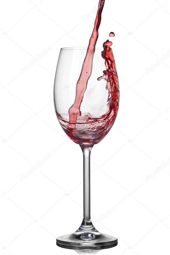 Splash of wine in wineglass on white