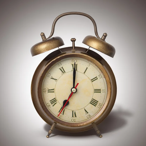 Brown old style alarm clock with shadow Stock Image