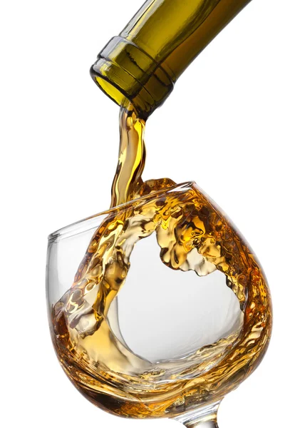 Cognac pouring into glass with splash isolated on white backgrou — Stock Photo, Image