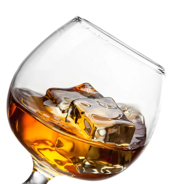 Splash of whiskey with ice in glass isolated on white background — Stock Photo, Image