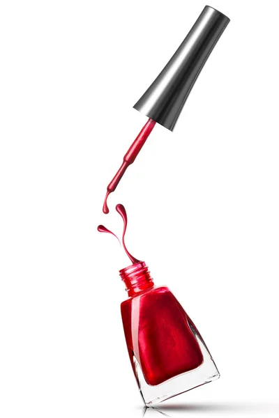 Frasco de verniz vermelho com respingo isolado em branco — Fotografia de Stock
