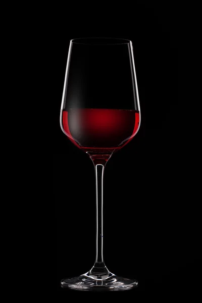 Red wine in glass on black — Stock Photo, Image