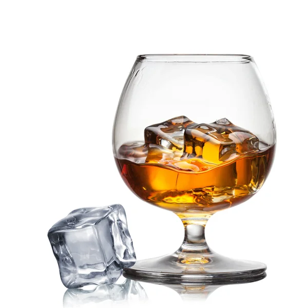 Splash of whiskey with ice in glass isolated on white — Stock Photo, Image