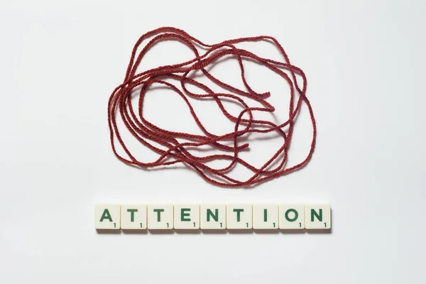 Attention Word Formed Scrabble Blocks Tangled Thread White Background Mental — Stockfoto