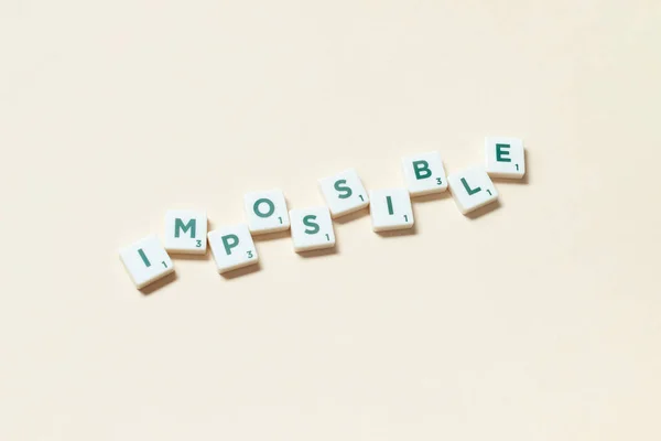 Impossible Word Formed Scrabble Tiles Beige Background Simple Creative Backdrop — Fotografia de Stock