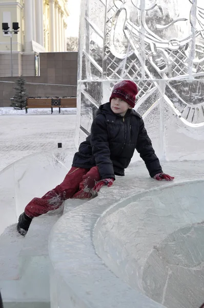 Portrét chlapce, který seděl na okraji ledový svah. — Stock fotografie
