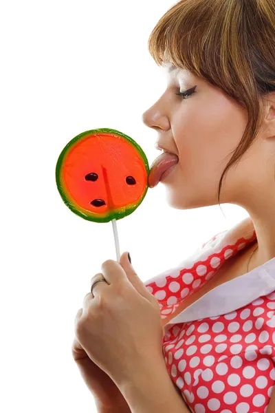 Girl licks a lollipop — Stock Photo, Image