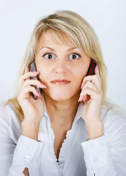 Blonde girl with two mobile phones — Stock Photo, Image