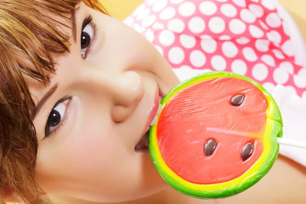 Attractive girl with a round lollipop — Stock Photo, Image