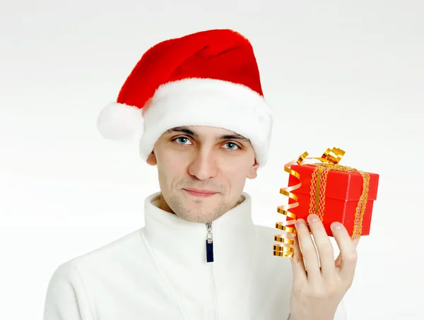 Man in a Santa hat with Christmas gift — Stock Photo, Image