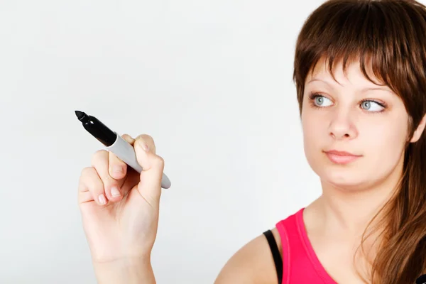 Young attractive girl writing in marker — Stock Photo, Image