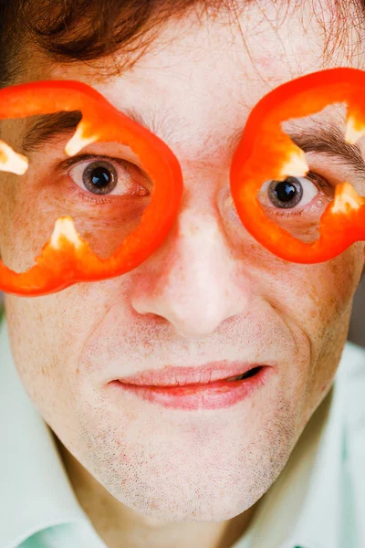 Young man with red pepper. humor — Stock Photo, Image