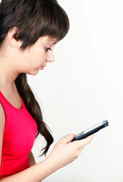 Young girl writing or reading sms — Stock Photo, Image