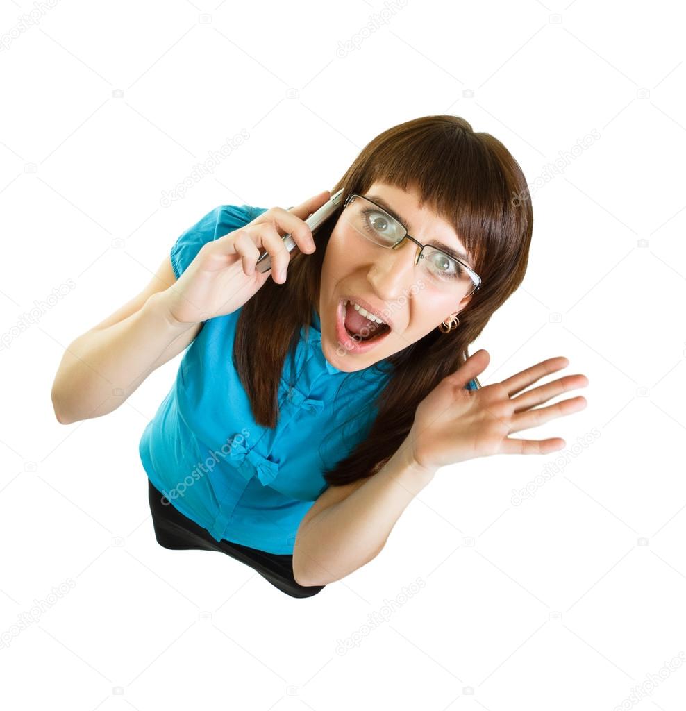 Girl with glasses emotionally speaks on the phone on white backg