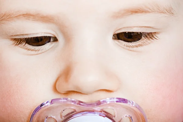 Rosto bebê com closeup chupeta. macro — Fotografia de Stock