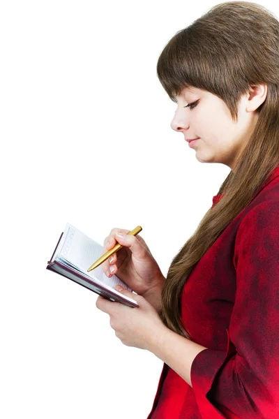 Menina bonita com caderno e caneta em um branco — Fotografia de Stock